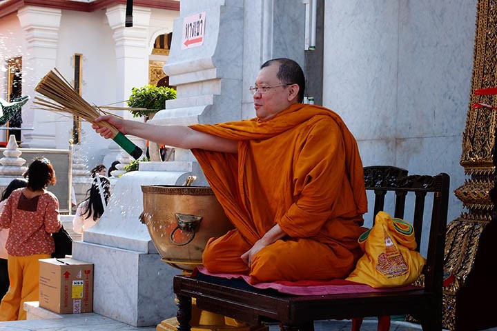 Monk blessing with holy water